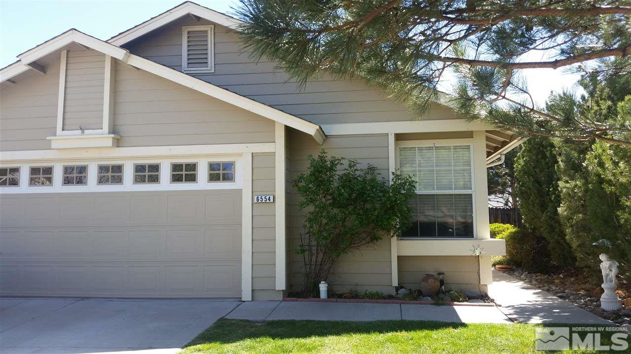 6554 Fall River Circle Reno, NV 89523 - Photo 1 of 1 a view of a yard in front of a house with plants and large tree