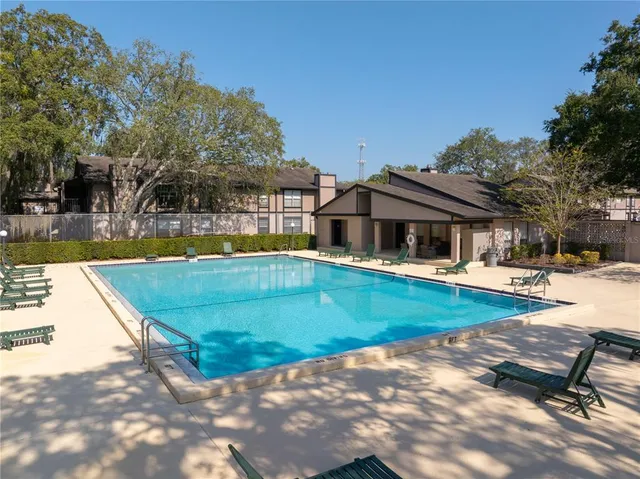 a view of a house with swimming pool and sitting area