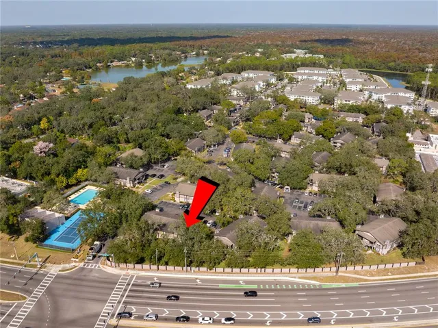 an aerial view of residential houses with outdoor space and swimming pool