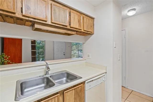 a kitchen with a sink and a refrigerator