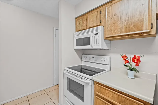 a kitchen with stainless steel appliances granite countertop white cabinets a stove top oven