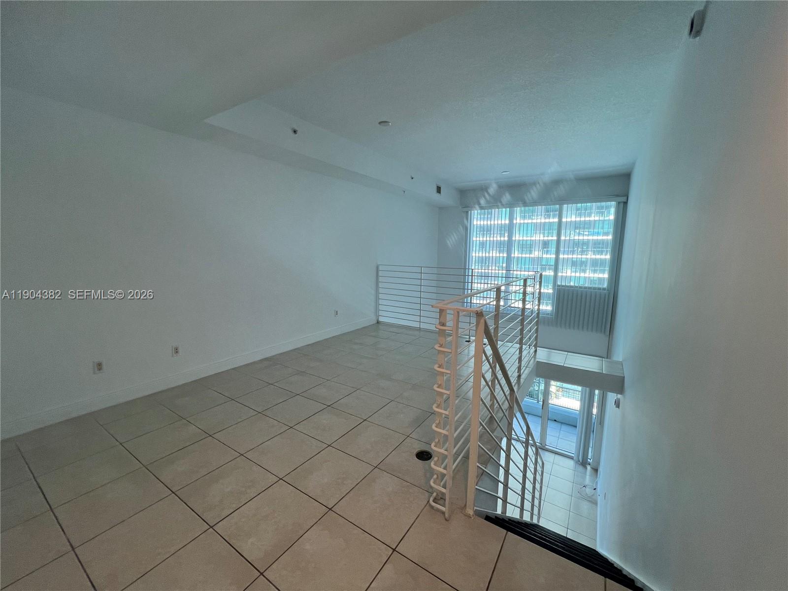 60 Southwest 13th Street, Unit 1612 Miami, FL 33130 - Photo 12 of 24 an empty room with windows