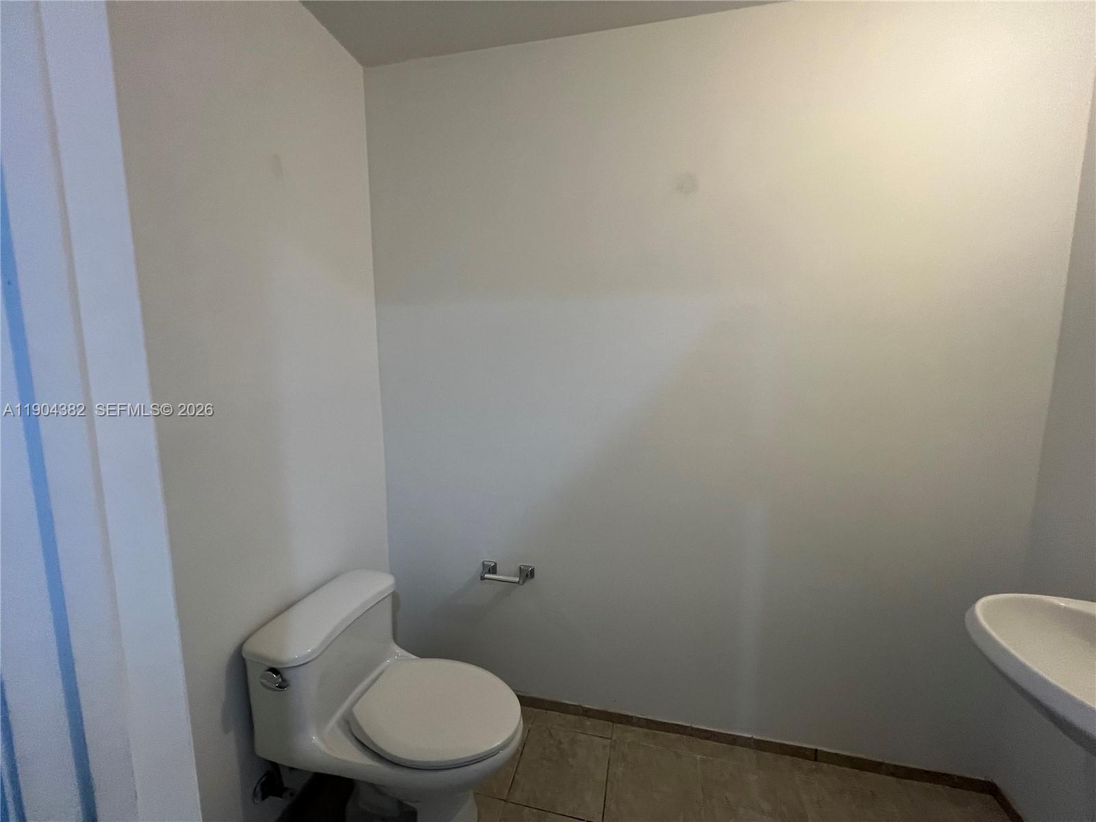 60 Southwest 13th Street, Unit 1612 Miami, FL 33130 - Photo 15 of 24 a white toilet sitting next to a white sink