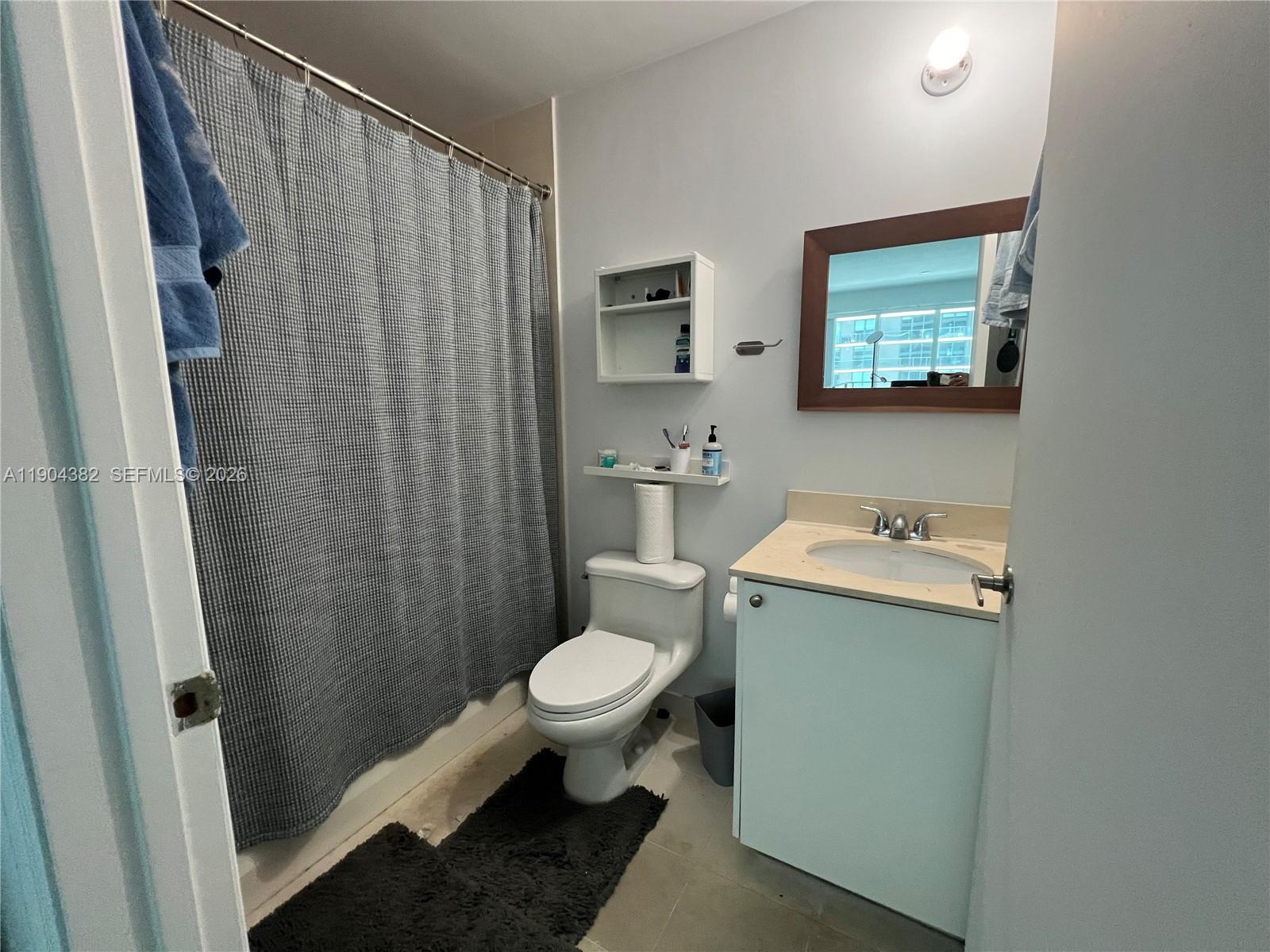 60 Southwest 13th Street, Unit 1612 Miami, FL 33130 - Photo 17 of 24 a bathroom with a sink toilet and shower