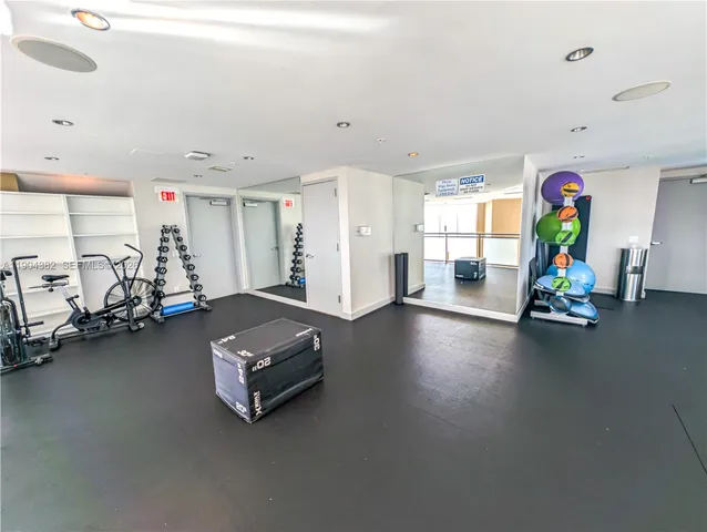 a room with gym equipment and a table
