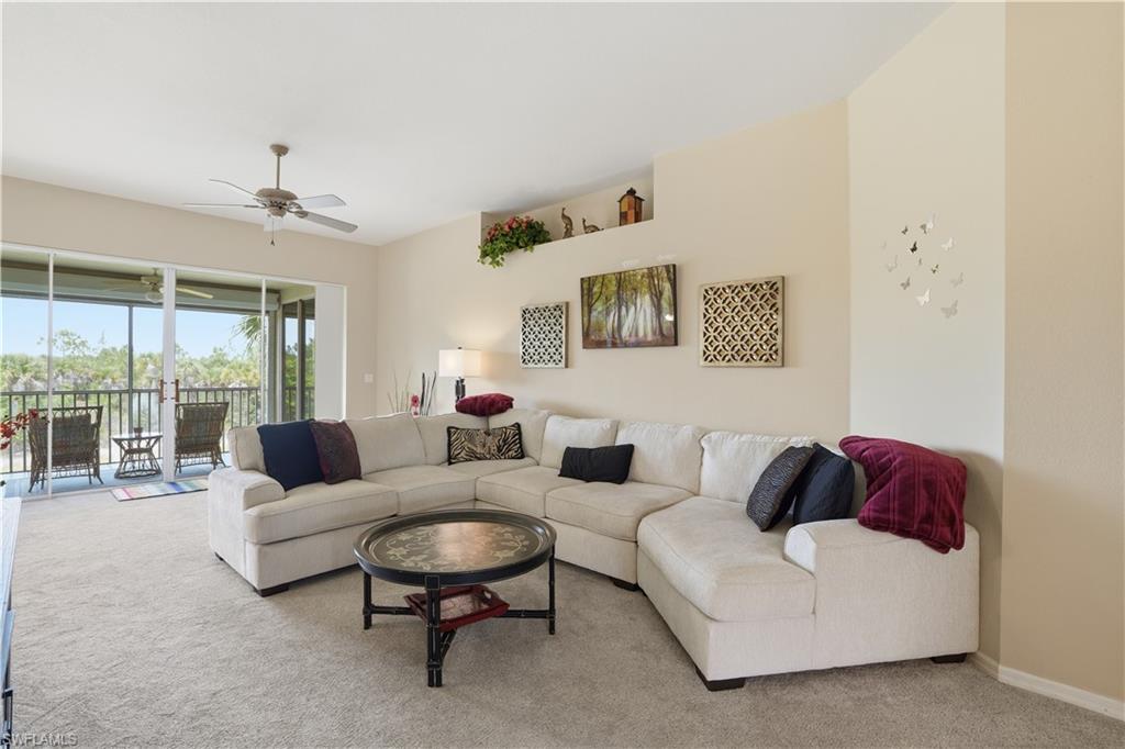 10871 Crooked River Road, Unit 202 Estero, FL 34135 - Photo 2 of 46 a living room with furniture and a large window