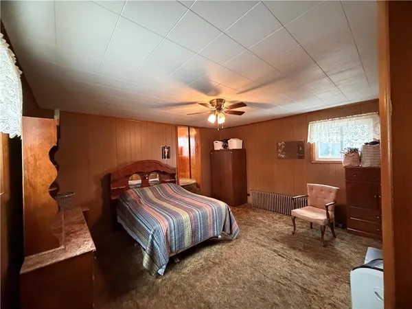 a bedroom with furniture and wooden floor