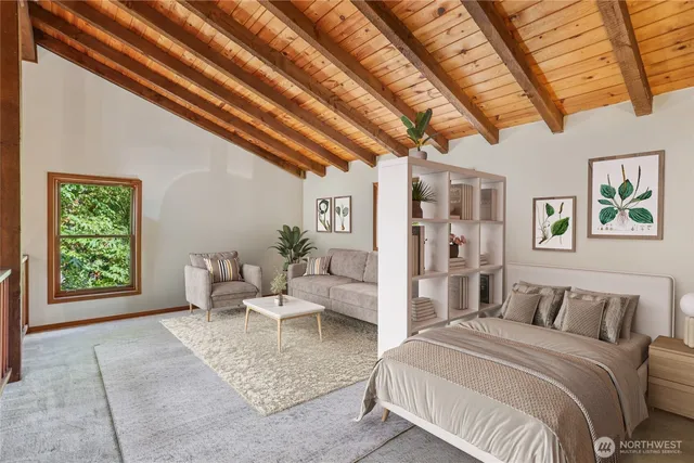 a spacious bedroom with a large bed couch and a window