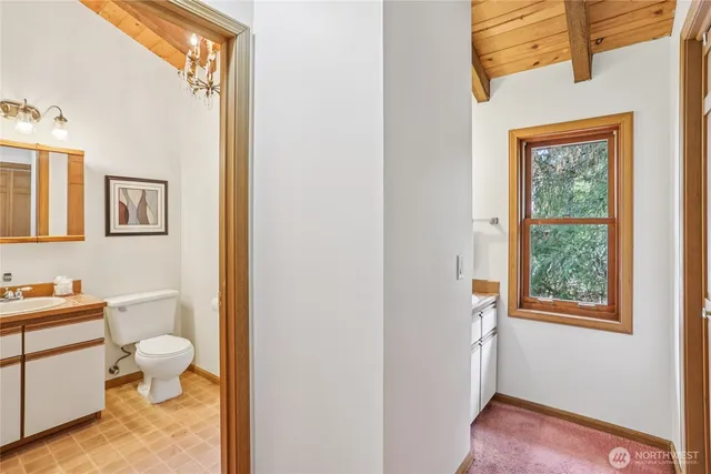 a bathroom with a toilet sink and a mirror