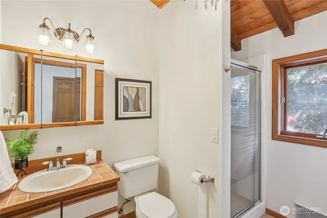 a bathroom with a toilet sink and mirror