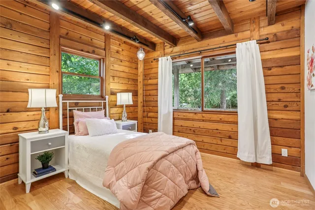 a bedroom with a bed and a large window