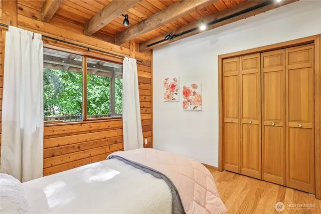 a bedroom with a large bed and a window