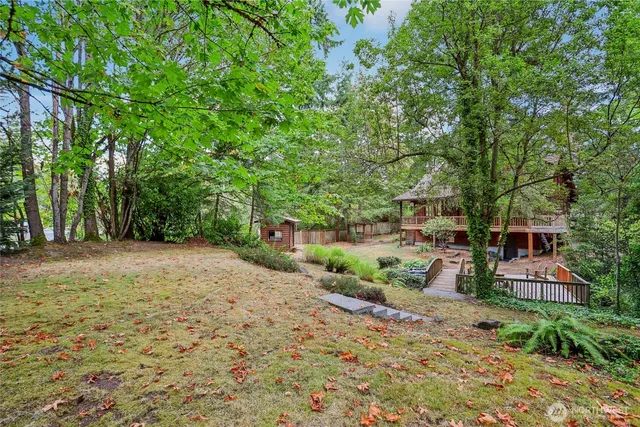 a view of a patio with a table chairs and a backyard