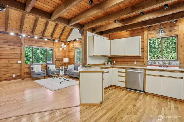 a kitchen with sink refrigerator and large window