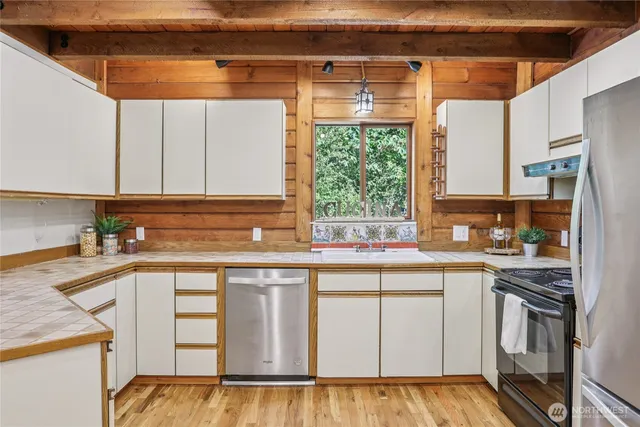 a kitchen with a sink stove and cabinets