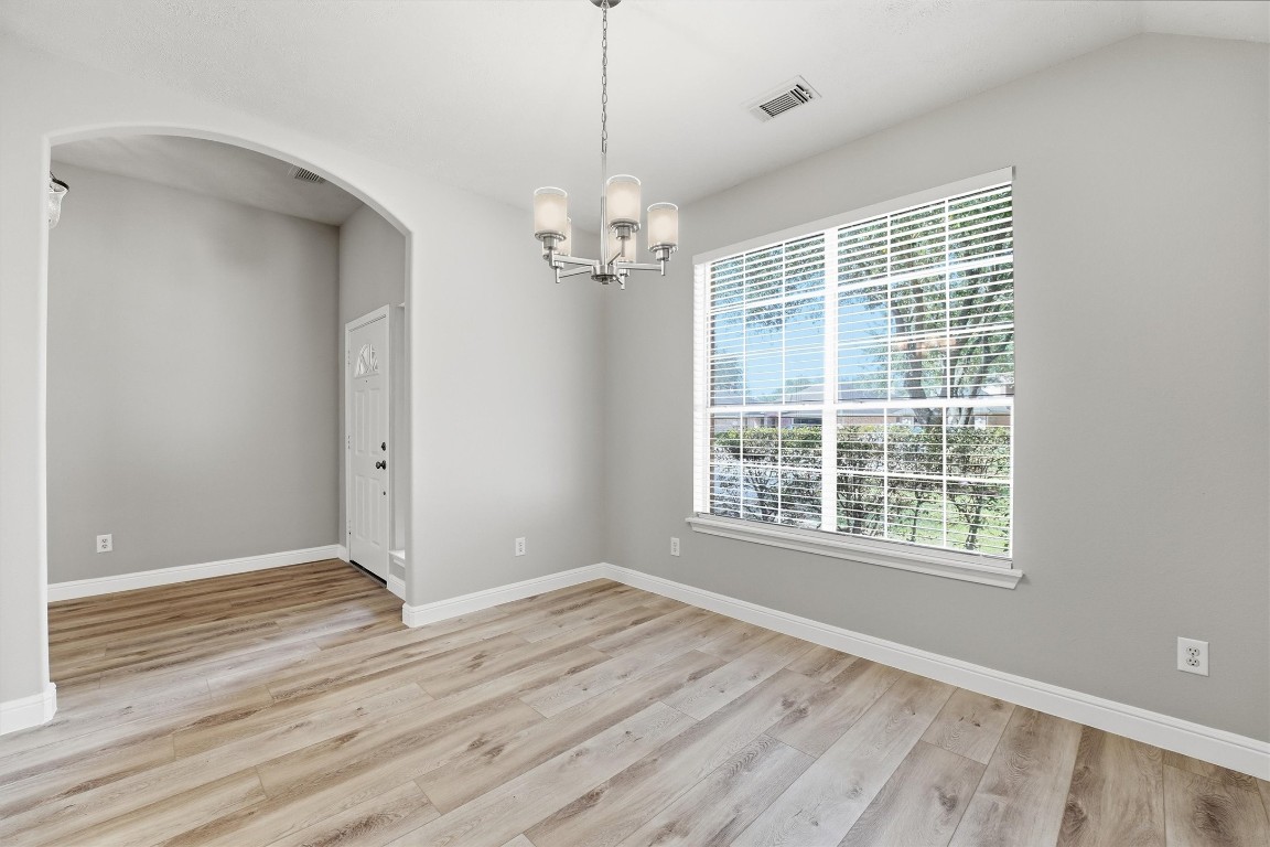 23301 Tuttle Court Porter, TX 77365 - Photo 13 of 50 a view of an empty room with wooden floor and a window