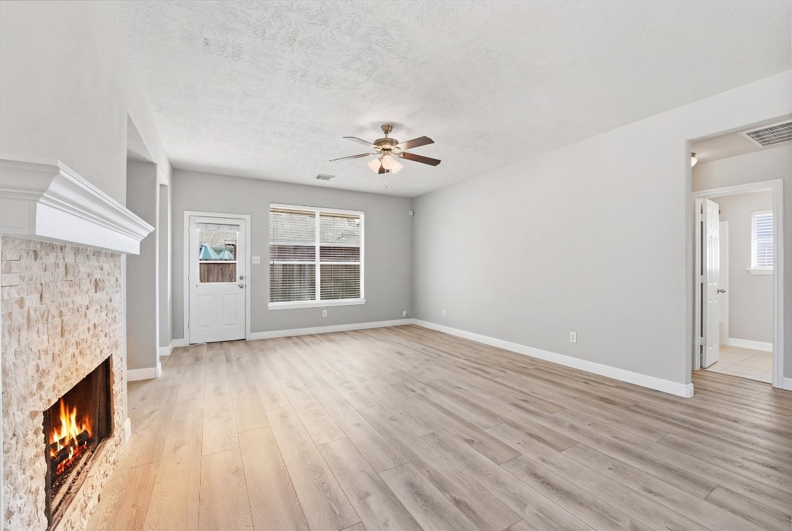 23301 Tuttle Court Porter, TX 77365 - Photo 22 of 50 wooden floor in an empty room with a fireplace