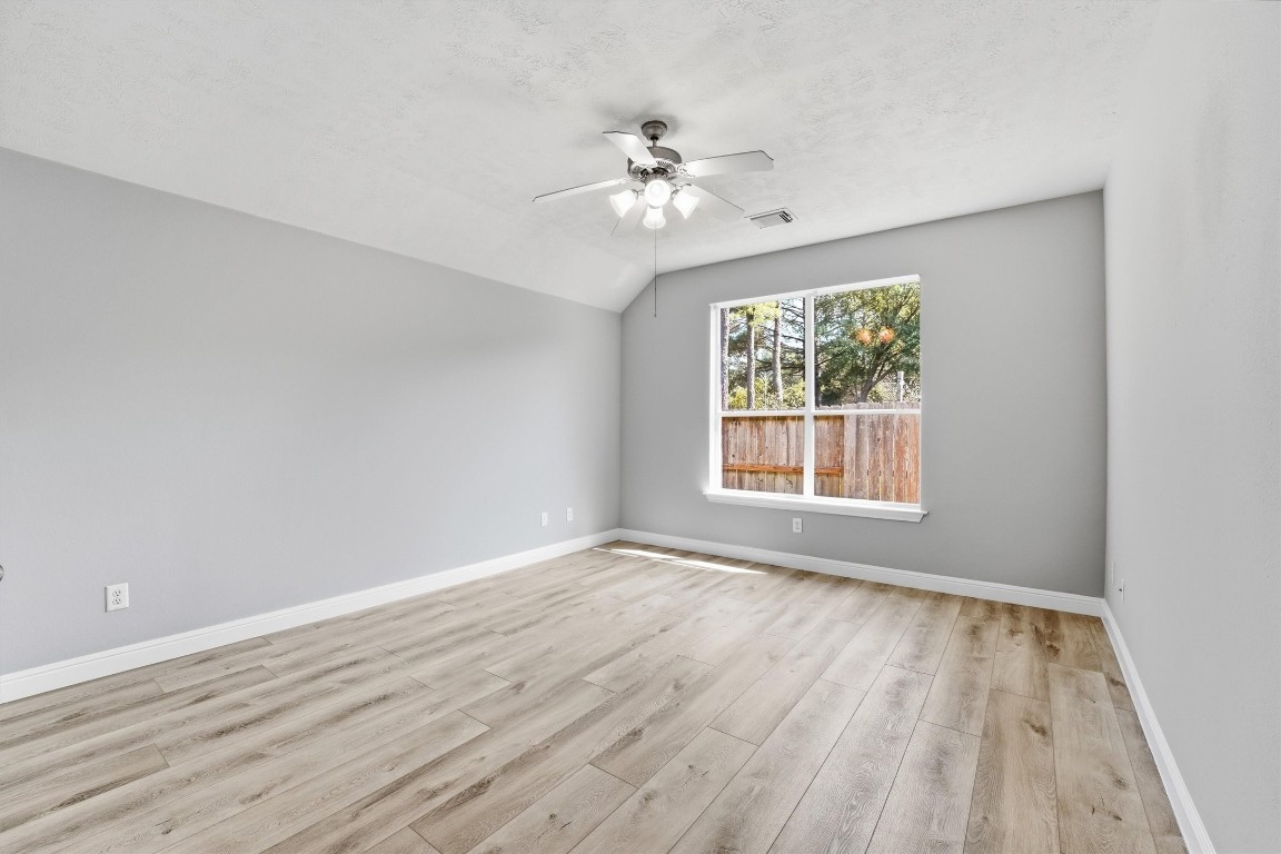 23301 Tuttle Court Porter, TX 77365 - Photo 27 of 50 a view of an empty room with wooden floor and a window