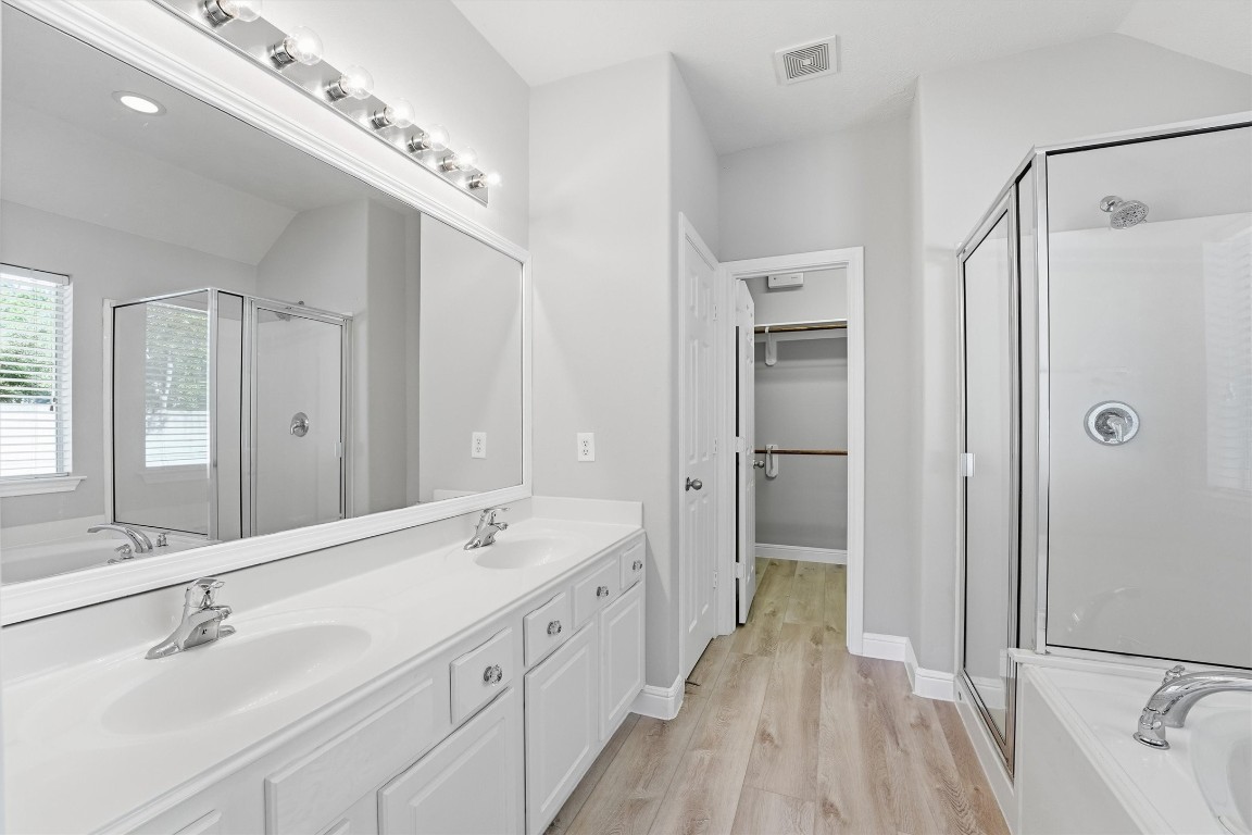 23301 Tuttle Court Porter, TX 77365 - Photo 30 of 50 a spacious bathroom with a double vanity sink mirror double and shower