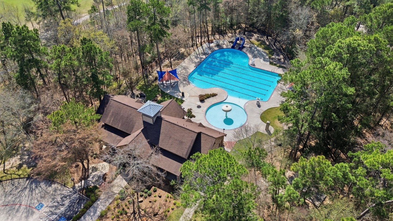 23301 Tuttle Court Porter, TX 77365 - Photo 48 of 50 a backyard of a house with table and chairs and a large tree