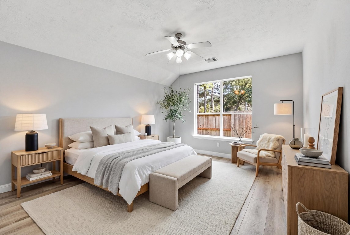 23301 Tuttle Court Porter, TX 77365 - Photo 7 of 50 a bedroom with a large bed couch and windows