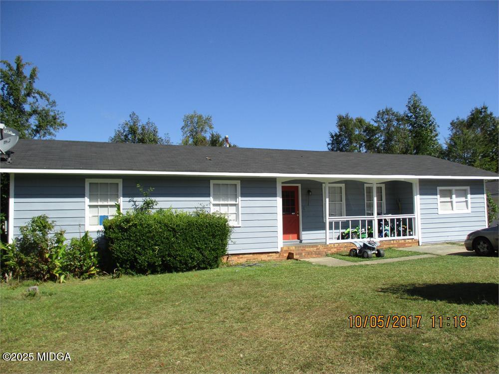 a front view of house with yard and green space