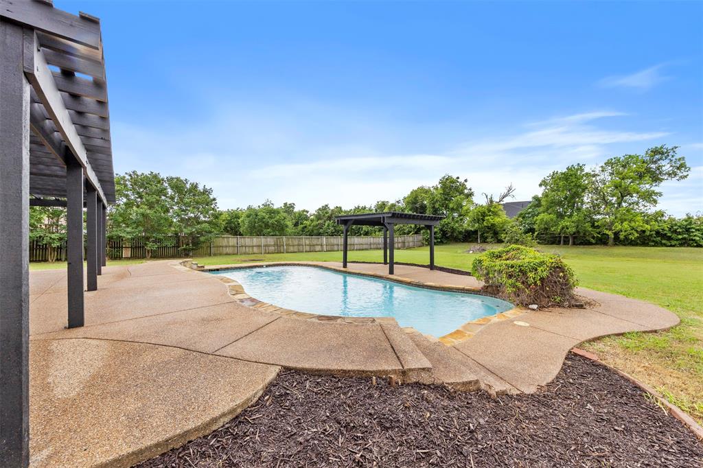 3931 Alpha Way Midlothian, TX 76065 - Photo 27 of 33 a view of a swimming pool with a patio and a yard