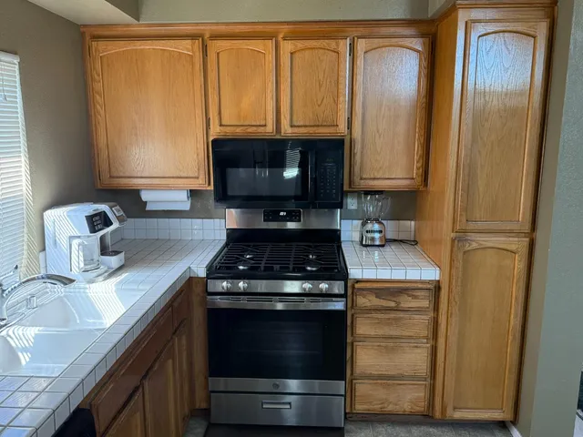 a kitchen with a refrigerator and a sink