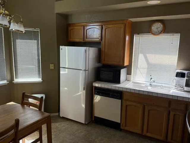 a kitchen with a sink appliances and cabinets