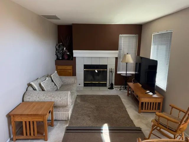 a view of a dining room with furniture and a chandelier