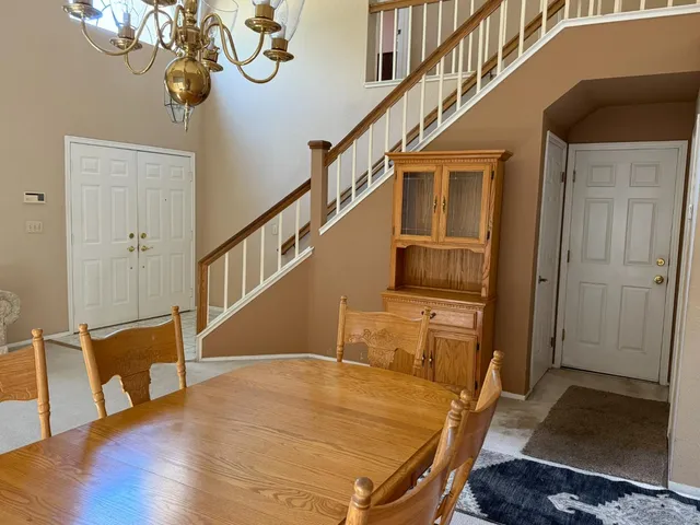 a living room with furniture chandelier and a window