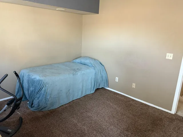 a bathroom with a granite countertop toilet and a sink