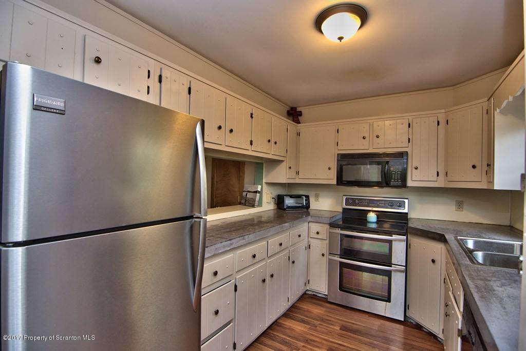 5275 Bloomington Road Moscow, PA 18444 - Photo 17 of 48 a kitchen with stainless steel appliances and white cabinets