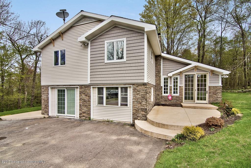 5275 Bloomington Road Moscow, PA 18444 - Photo 2 of 48 a view of a white house with a sink and yard