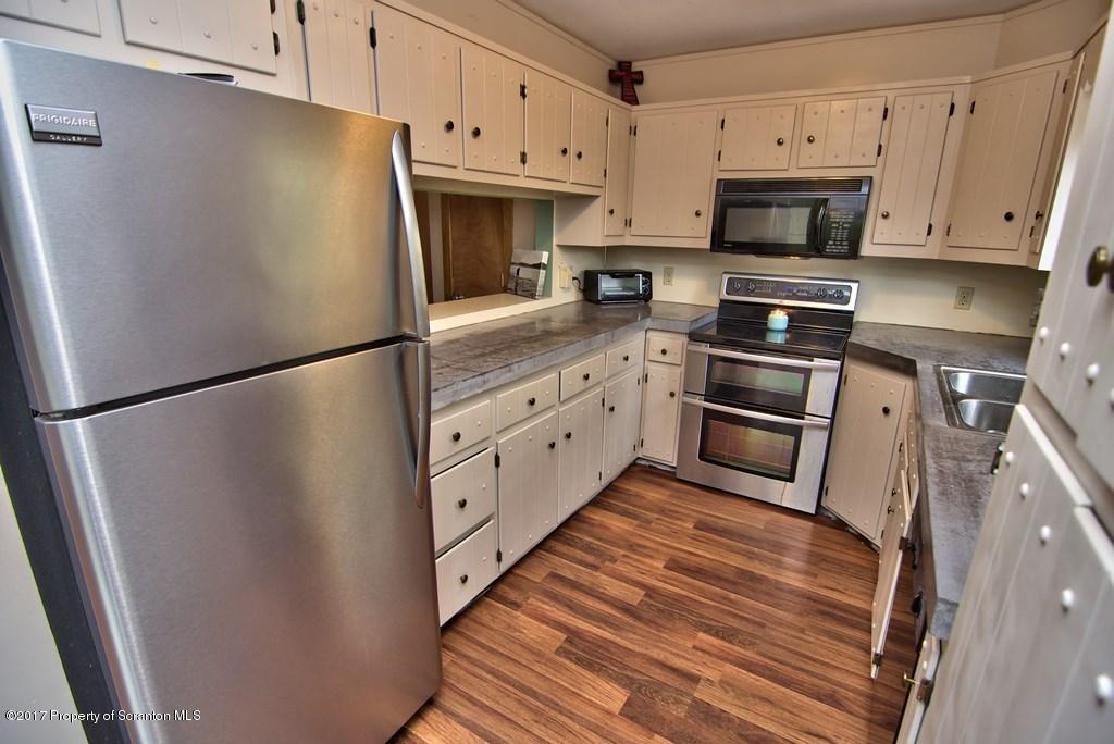 5275 Bloomington Road Moscow, PA 18444 - Photo 21 of 48 a kitchen with stainless steel appliances a refrigerator sink and microwave