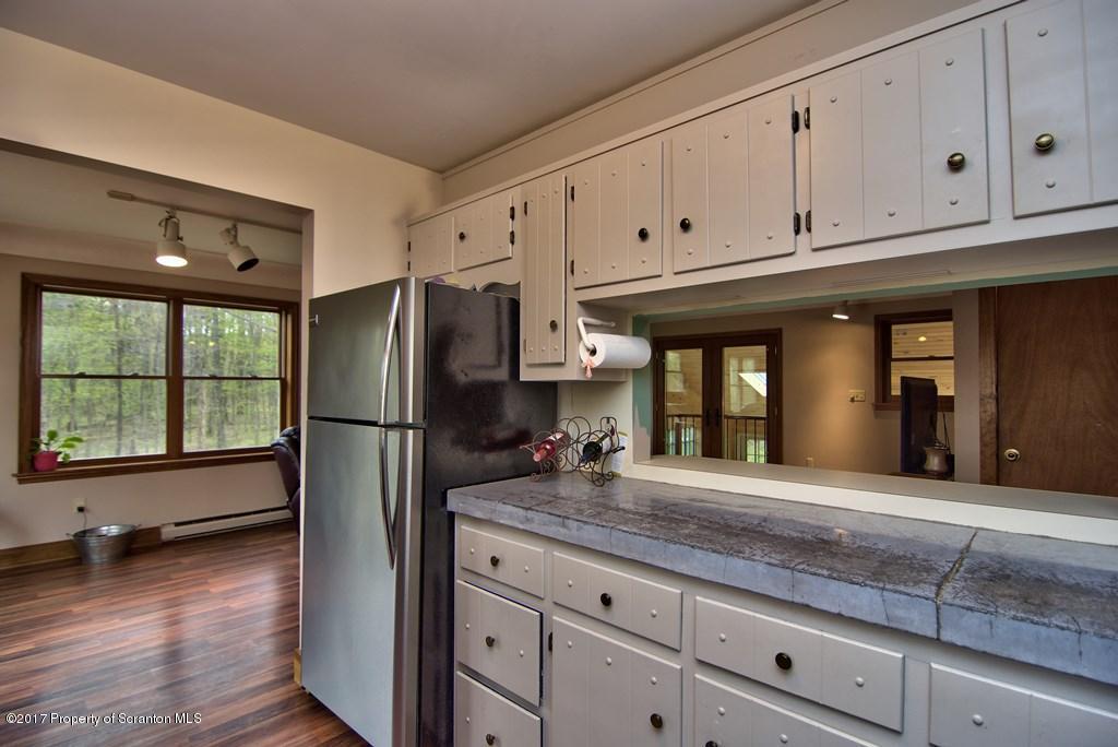 5275 Bloomington Road Moscow, PA 18444 - Photo 22 of 48 a kitchen with stainless steel appliances granite countertop a refrigerator and cabinets
