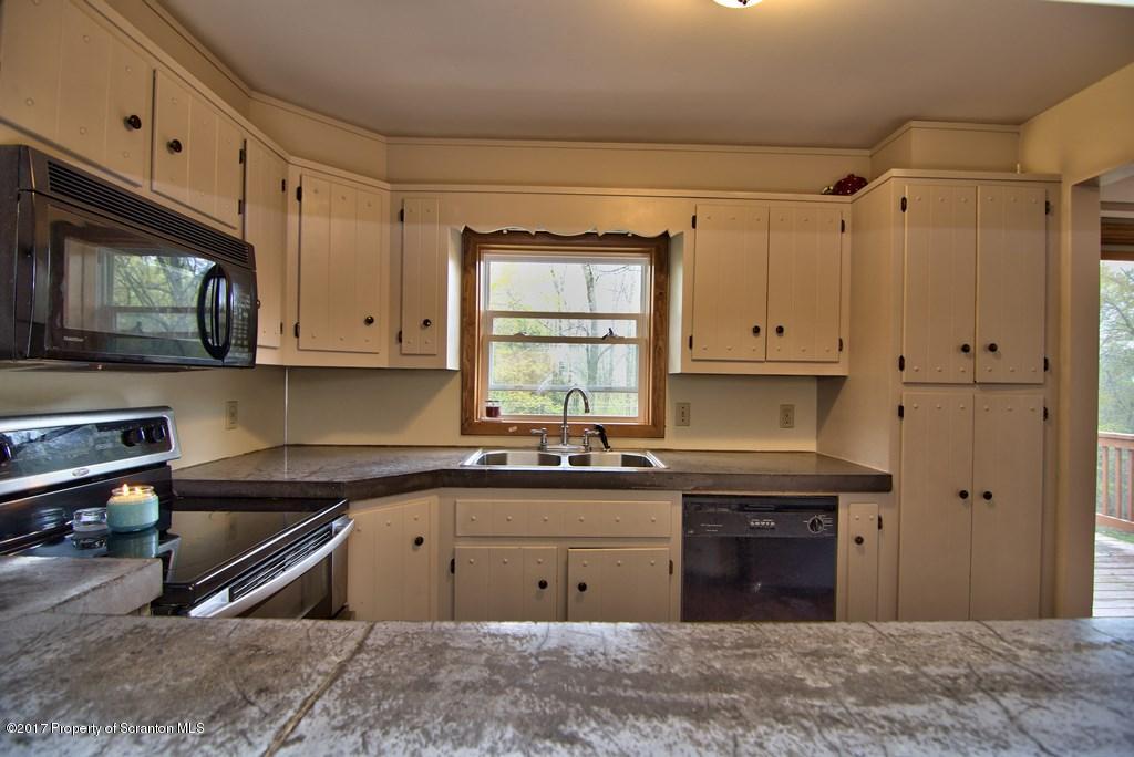 5275 Bloomington Road Moscow, PA 18444 - Photo 23 of 48 a kitchen with granite countertop a sink cabinets and stainless steel appliances