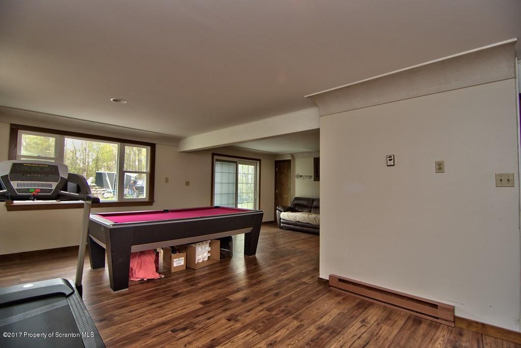 5275 Bloomington Road Moscow, PA 18444 - Photo 26 of 48 a living room with a pool table and a couch