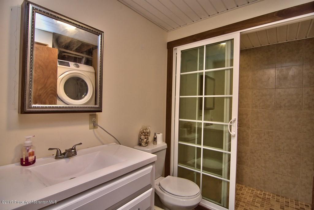 5275 Bloomington Road Moscow, PA 18444 - Photo 30 of 48 a bathroom with a sink a toilet and shower
