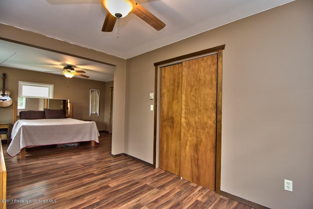5275 Bloomington Road Moscow, PA 18444 - Photo 35 of 48 a bedroom with a bed and wooden floor