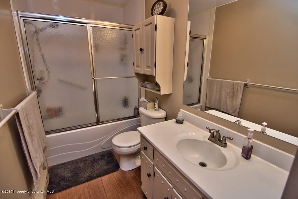 5275 Bloomington Road Moscow, PA 18444 - Photo 39 of 48 a bathroom with a sink toilet and shower