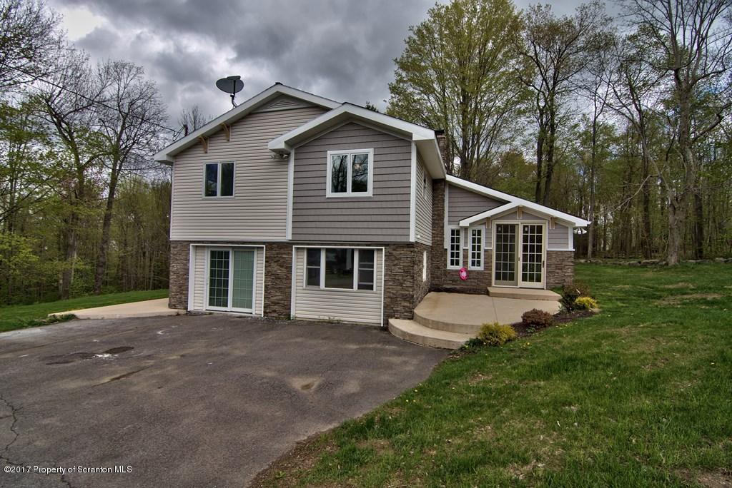 5275 Bloomington Road Moscow, PA 18444 - Photo 5 of 48 a front view of a house with garden