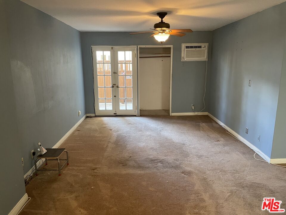 3640 Cardiff Avenue, Unit 108 Los Angeles, CA 90034 - Photo 4 of 14 an empty room with windows and chandelier fan