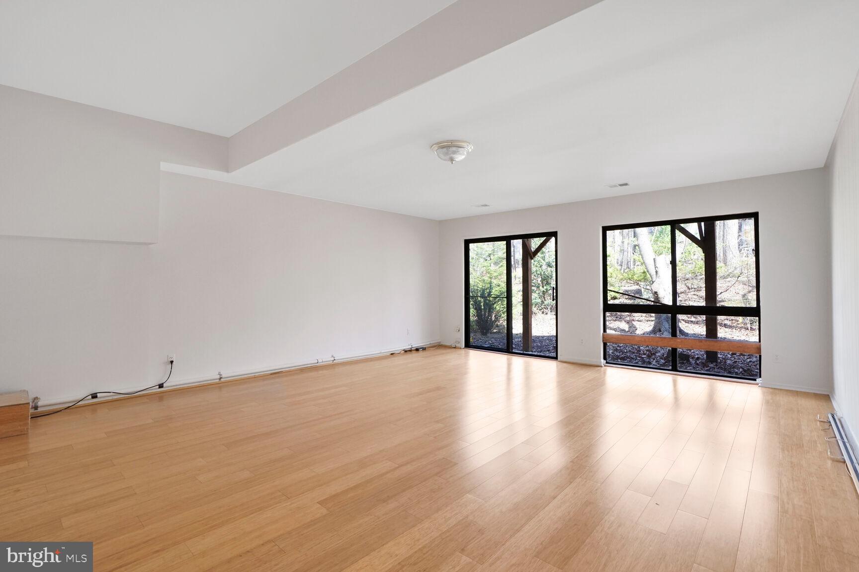 1526 Scandia Circle Reston, VA 20190 - Photo 17 of 22 a view of an empty room with wooden floor and a window