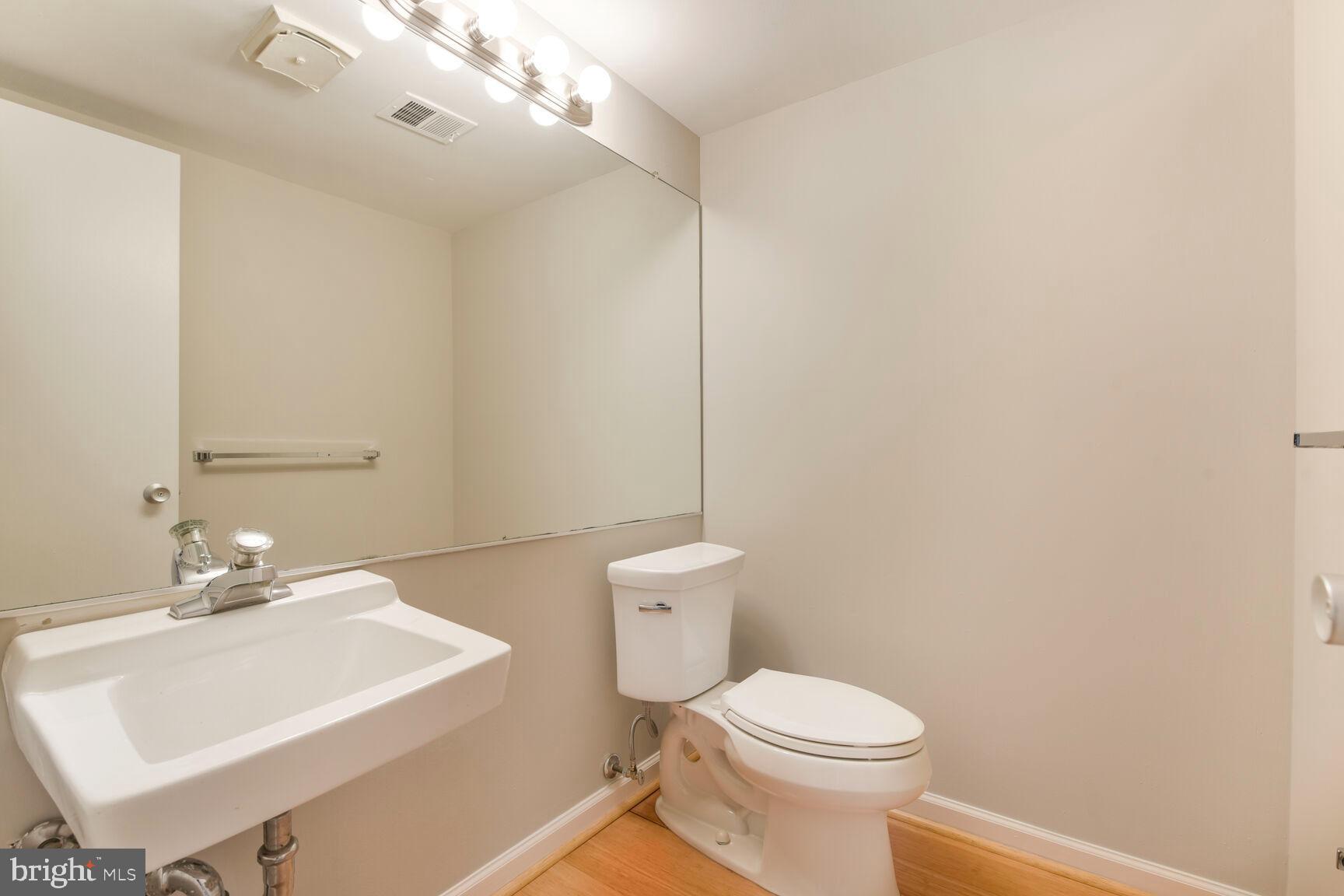 1526 Scandia Circle Reston, VA 20190 - Photo 18 of 22 a bathroom with a sink a toilet and a mirror