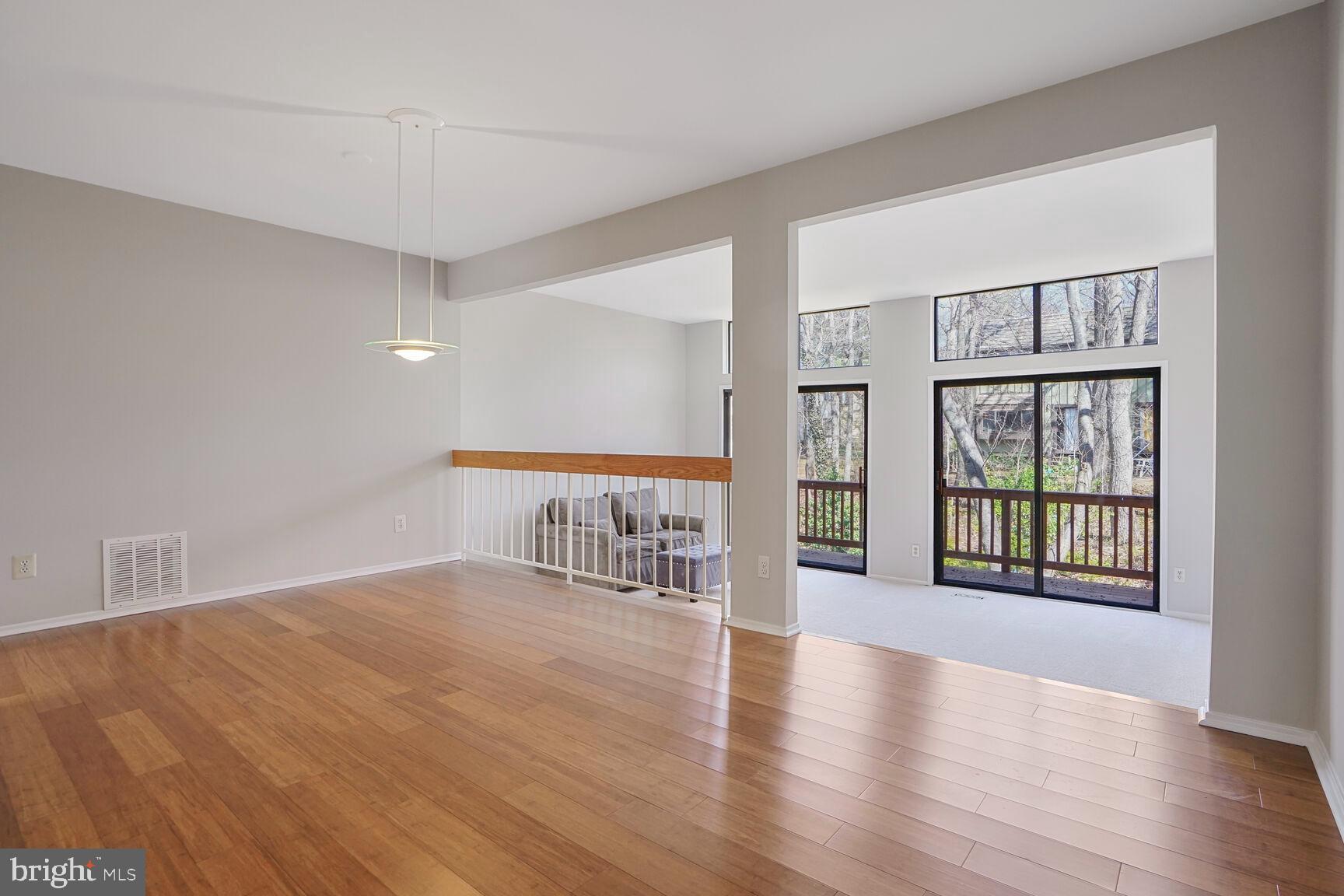 1526 Scandia Circle Reston, VA 20190 - Photo 4 of 22 a view of an empty room with wooden floor and a window