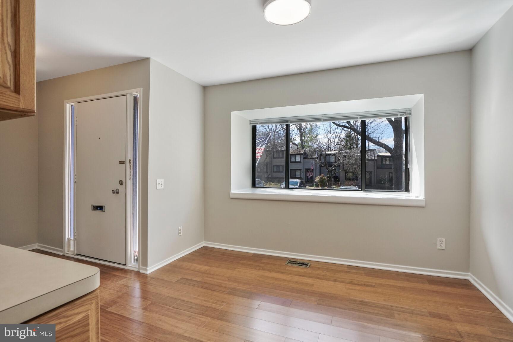 1526 Scandia Circle Reston, VA 20190 - Photo 8 of 22 an empty room with wooden floor and windows