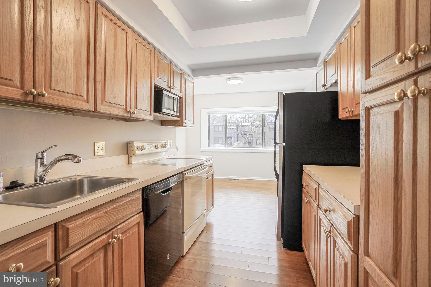 1526 Scandia Circle Reston, VA 20190 - Photo 9 of 22 a kitchen with stainless steel appliances granite countertop a refrigerator a stove a sink and a microwave