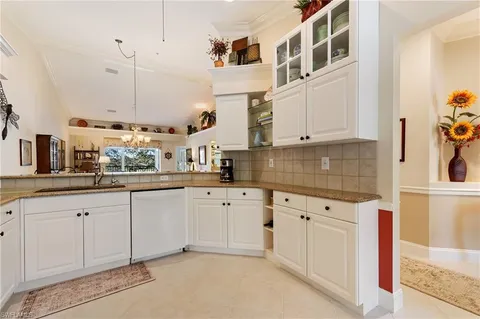 a kitchen with cabinets and window