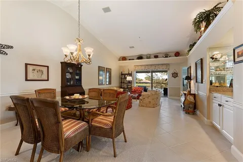 a view of a dining room with furniture and chandelier